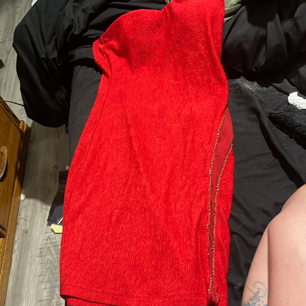 Super cute, bright red mini dress with chain accents and sheer cut outs